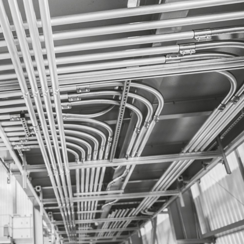 A large-scale industrial piping system designed for material transport in a manufacturing facility, featuring multiple interconnected tubes for efficient conveying operations.