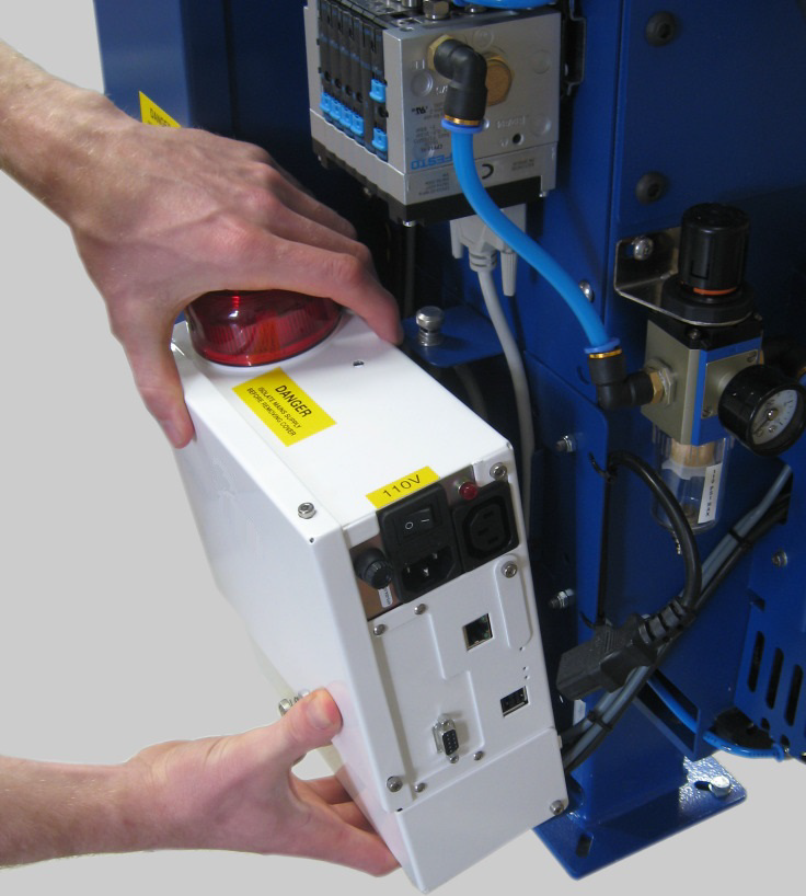 Control module lifted off an existing blender frame by hand